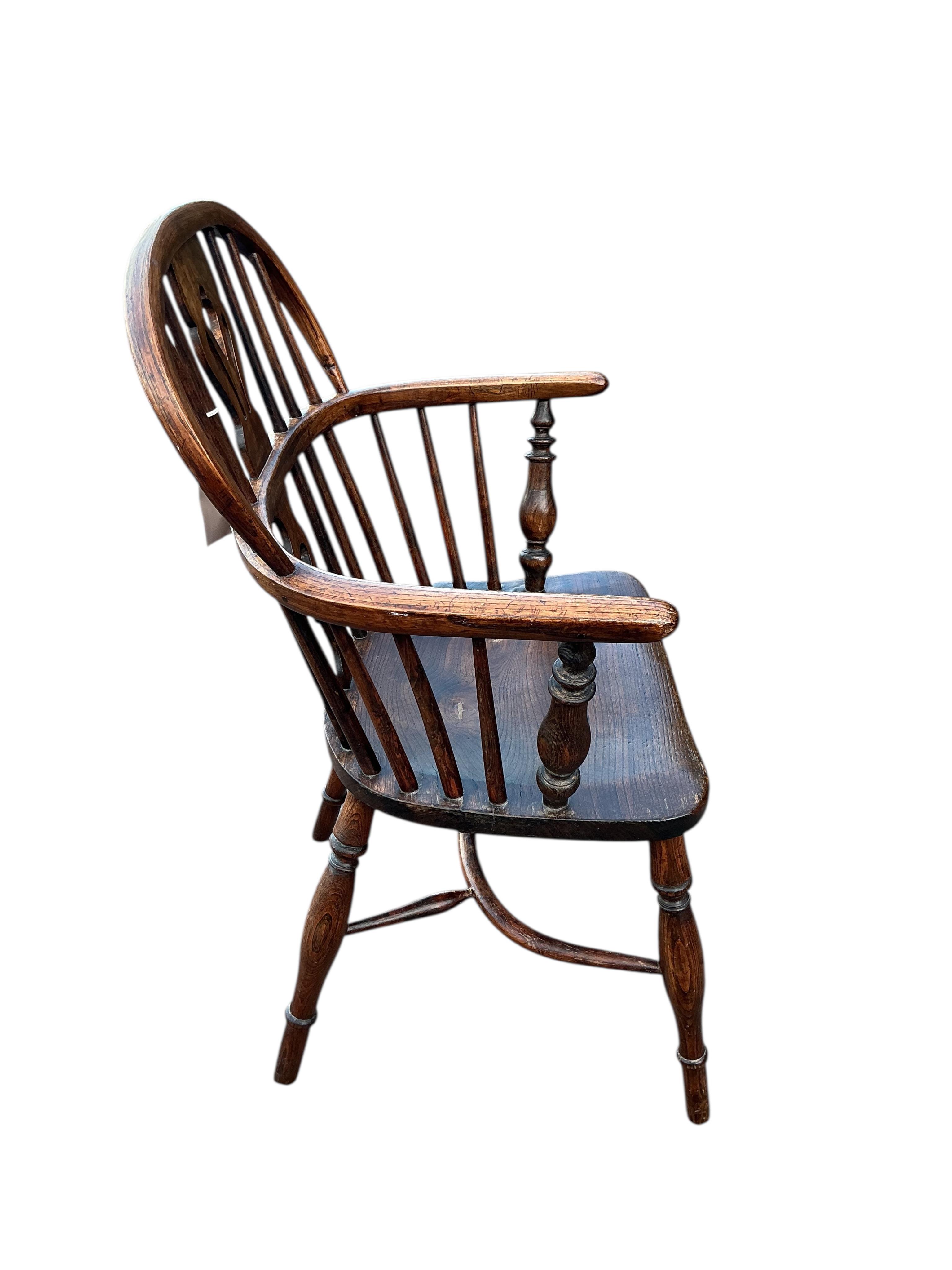 A 19th century Windsor ash and elm elbow chair with crinoline stretcher, width 57cm, depth 38cm, height 91cm
